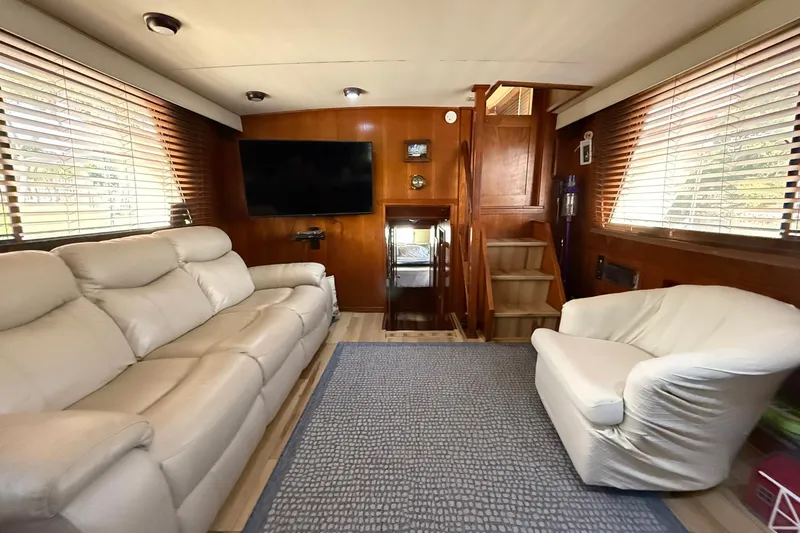 Luv'n Life Yacht Photos Pics Luxurious interior of 1989 Atlantic 47 Motor Yacht with plush seating and wooden accents.