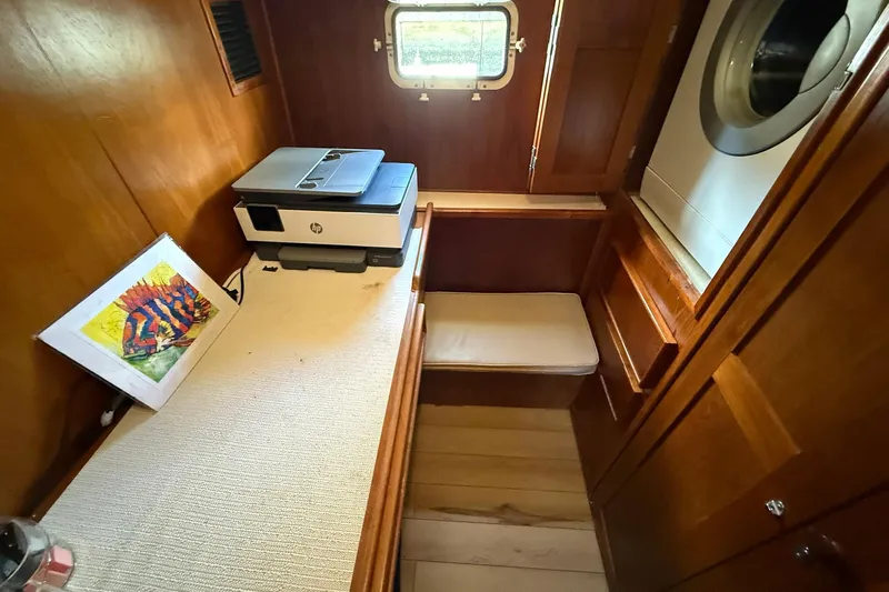 Luv'n Life Yacht Photos Pics Cozy cabin interior of 1989 Atlantic 47 Motor Yacht with printer and artwork.