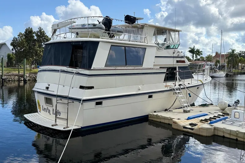 Luv'n Life Yacht Photos Pics 1989 Atlantic 47 Motor Yacht docked in a serene marina setting.