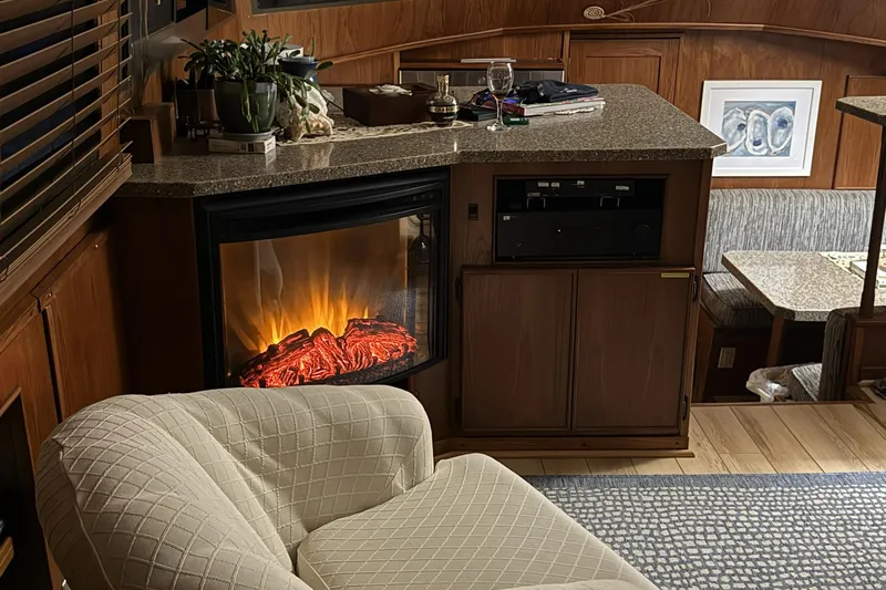 Luv'n Life Yacht Photos Pics Cozy interior of 1989 Atlantic 47 Motor Yacht with fireplace and seating area.