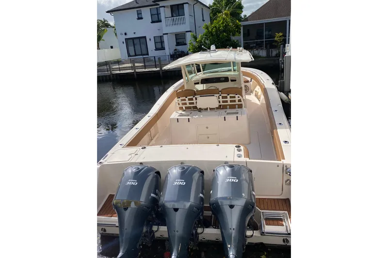 Yacht Photos Pics 2013 Grady-White Canyon 366 boat with triple Yamaha 300 engines docked by waterfront homes.
