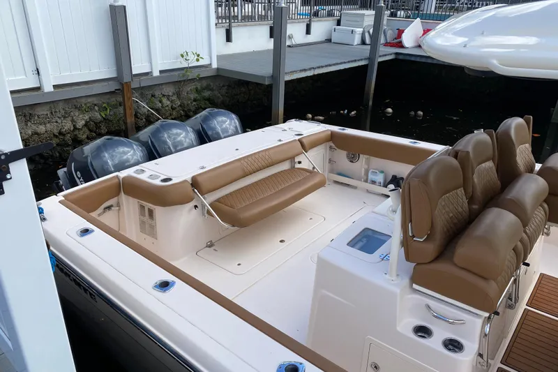  Yacht Photos Pics 2013 Grady-White Canyon 366 boat with tan seating and triple outboard engines.