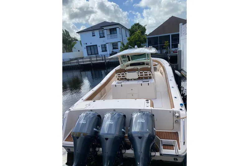  Yacht Photos Pics 2013 Grady-White Canyon 366 boat with triple 300 horsepower engines docked by waterfront homes.