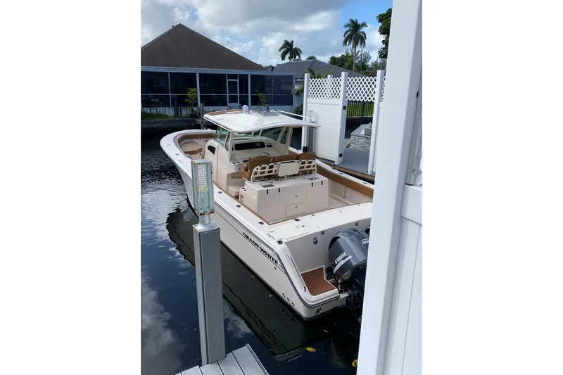  Yacht Photos Pics 2013 Grady-White Canyon 366 boat docked near waterfront home.
