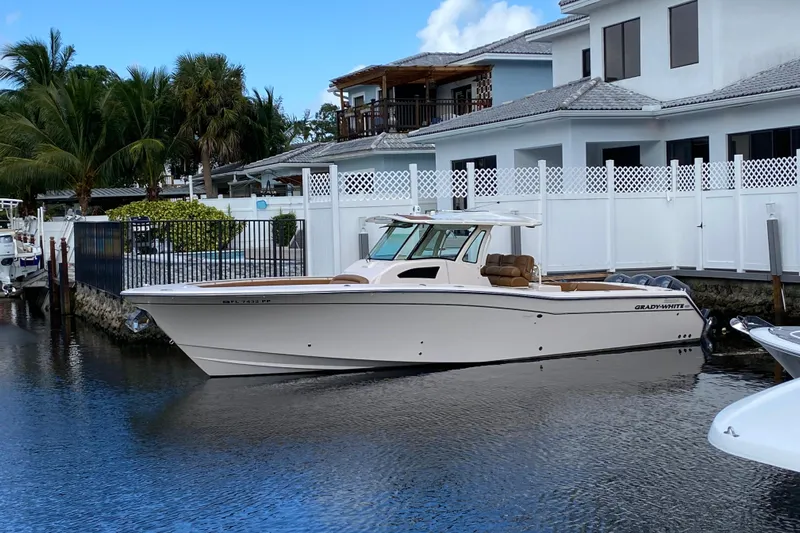  Yacht Photos Pics 2013 Grady-White Canyon 366 boat docked by waterfront homes.