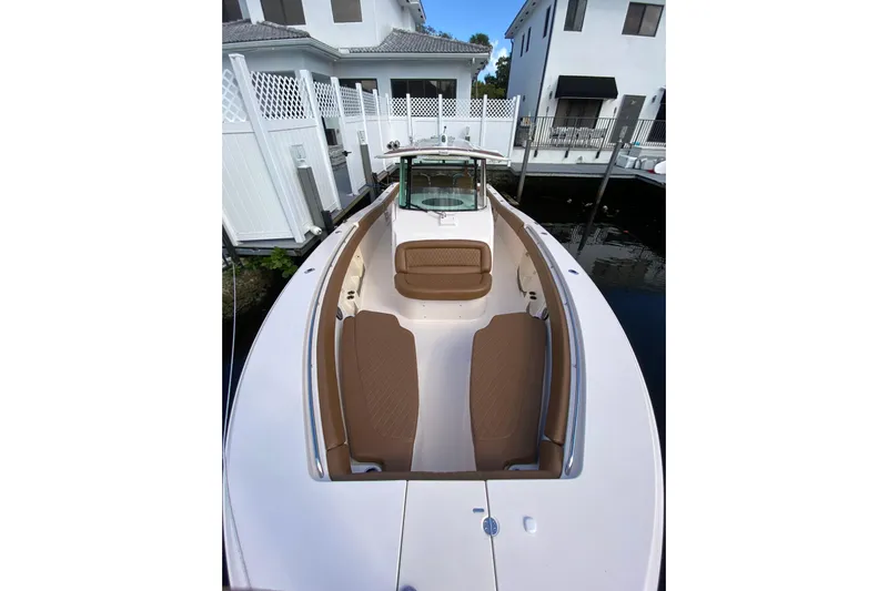  Yacht Photos Pics 2013 Grady-White Canyon 366 boat with tan seating, docked near waterfront homes.