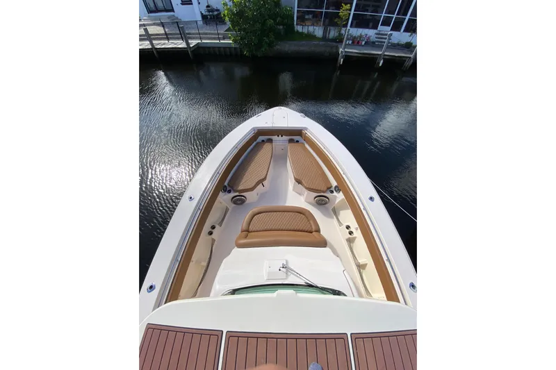  Yacht Photos Pics 2013 Grady-White Canyon 366 boat with cushioned seating, docked by a canal.