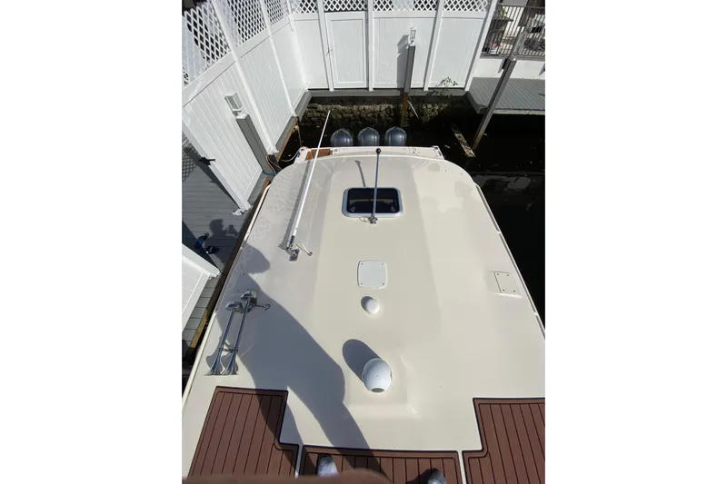  Yacht Photos Pics 2013 Grady-White Canyon 366 boat deck view, docked near white fencing.