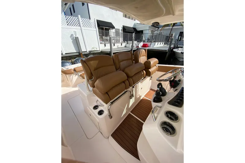  Yacht Photos Pics 2013 Grady-White Canyon 366 boat interior with brown leather seating and control panel.