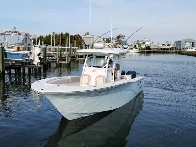 Reel Salty Yacht Photos Pics 2015 Sea Fox 286 Commander boat cruising in a marina.