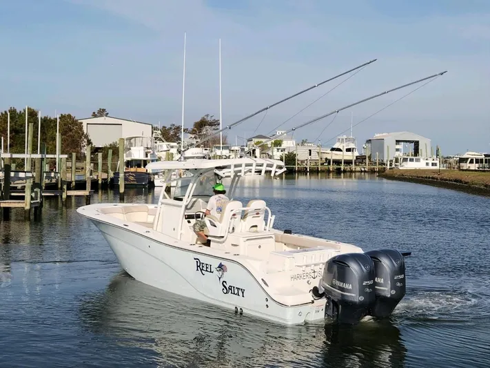 Reel Salty Yacht Photos Pics 2015 Sea Fox 286 Commander boat with dual Yamaha engines in a marina.
