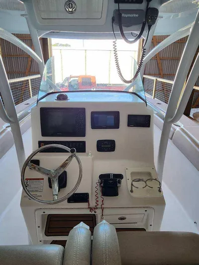 Reel Salty Yacht Photos Pics 2015 Sea Fox 286 Commander boat helm with steering wheel and navigation equipment.