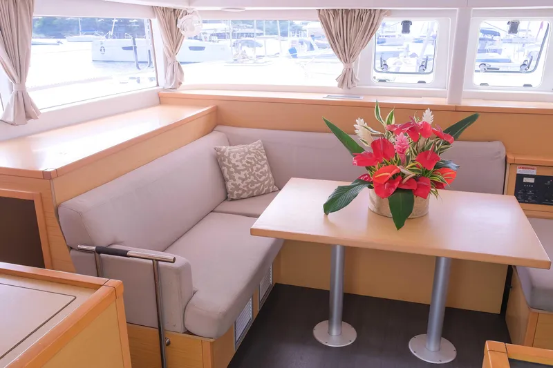 Larimar Yacht Photos Pics Interior of 2015 Lagoon 400 S2 yacht with cozy seating and floral centerpiece.