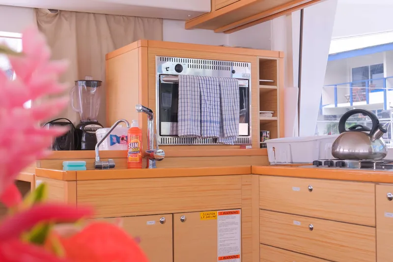 Larimar Yacht Photos Pics Modern kitchen interior of 2015 Lagoon 400 S2 catamaran with appliances and wooden cabinetry.