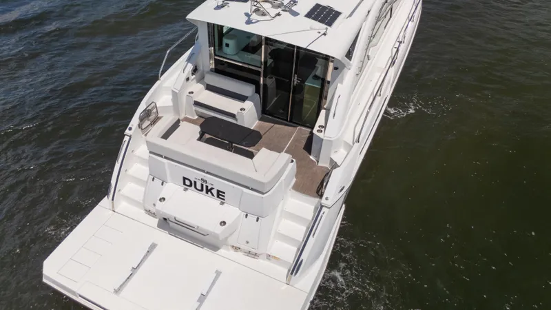 Duke Yacht Photos Pics 2018 Cruisers Yachts 50 Cantius on water, rear view, spacious deck.