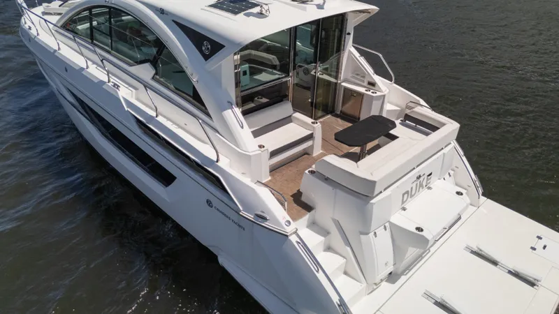 Duke Yacht Photos Pics 2018 Cruisers Yachts 50 Cantius on water, rear view, sleek design, spacious deck.