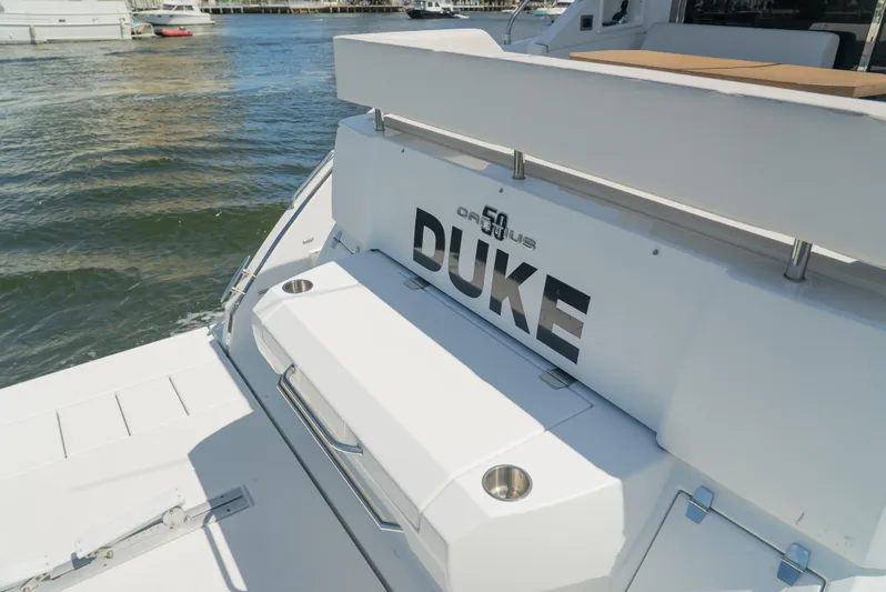 Duke Yacht Photos Pics 2018 Cruisers Yachts 50 Cantius, rear view, docked on water.
