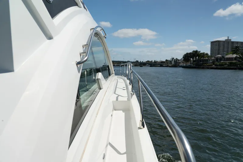 Duke Yacht Photos Pics 2018 Cruisers Yachts 50 Cantius cruising on a sunny day, side view of deck and railing.
