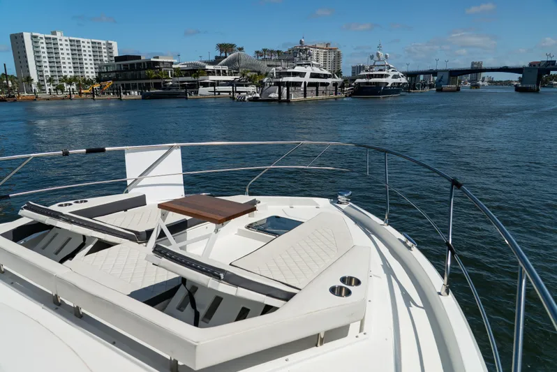 Duke Yacht Photos Pics 2018 Cruisers Yachts 50 Cantius on water, featuring luxurious deck seating and scenic marina view.