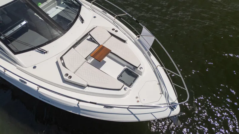 Duke Yacht Photos Pics 2018 Cruisers Yachts 50 Cantius boat with sunbathing area on deck, floating on water.