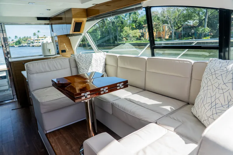 Duke Yacht Photos Pics Luxurious interior of 2018 Cruisers Yachts 50 Cantius with elegant seating and table.