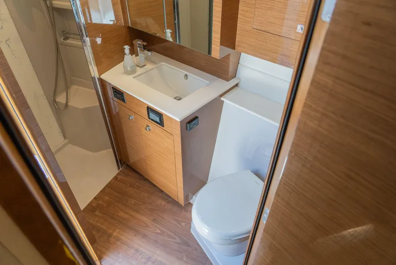Duke Yacht Photos Pics Luxurious bathroom in 2018 Cruisers Yachts 50 Cantius with modern fixtures and wood accents.