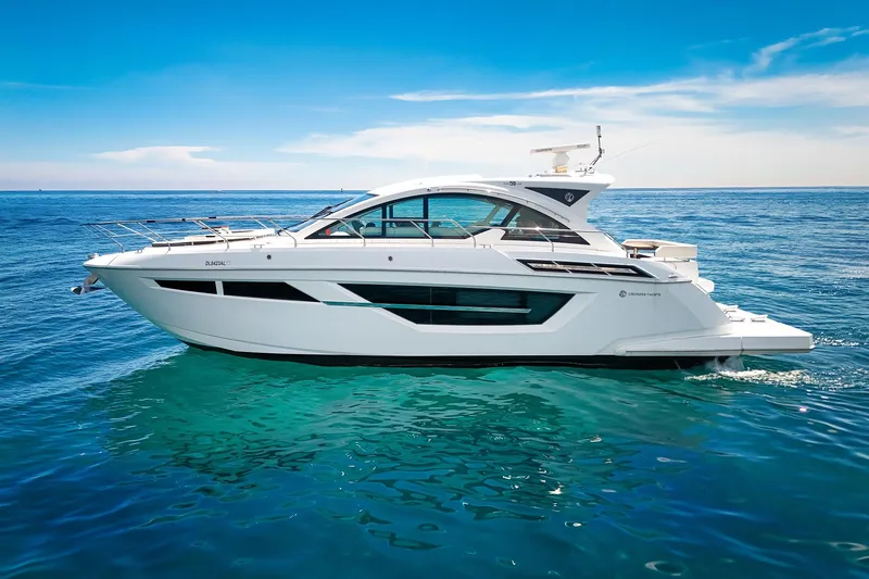 Duke Yacht Photos Pics 2018 Cruisers Yachts 50 Cantius on open water under clear blue sky.
