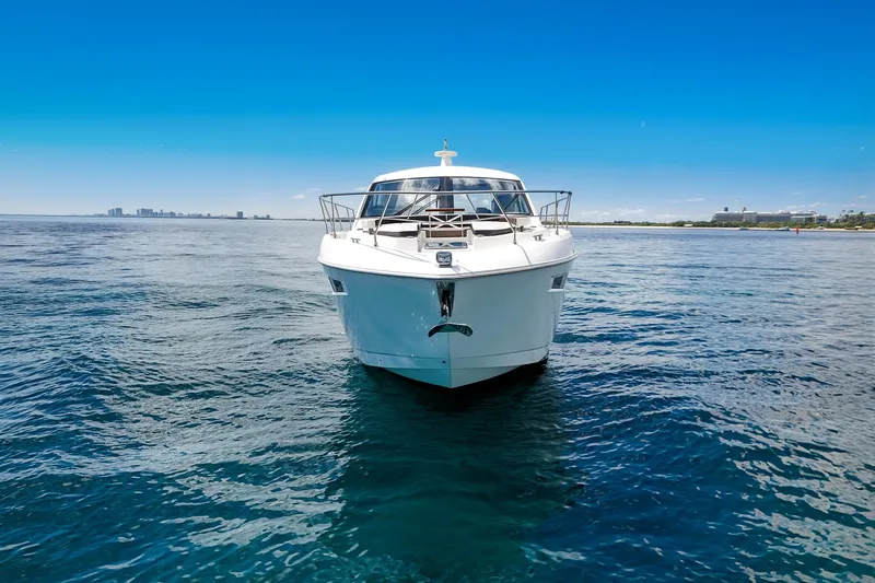 Duke Yacht Photos Pics 2018 Cruisers Yachts 50 Cantius on open water, clear blue sky background.