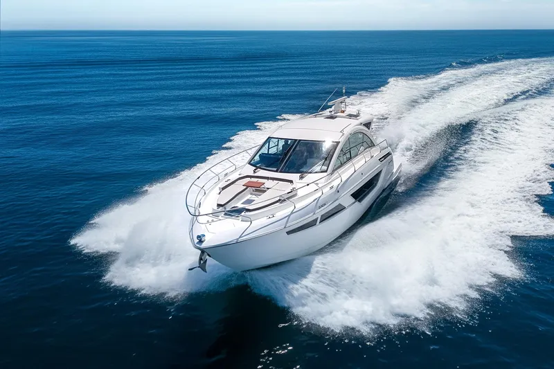 Duke Yacht Photos Pics 2018 Cruisers Yachts 50 Cantius speeding on open ocean waters.