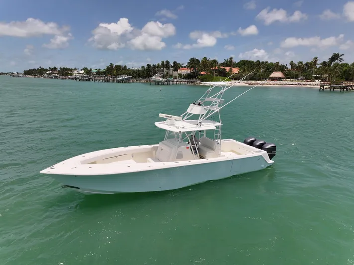  Yacht Photos Pics 2015 SeaVee 370z boat on turquoise water with coastal background.