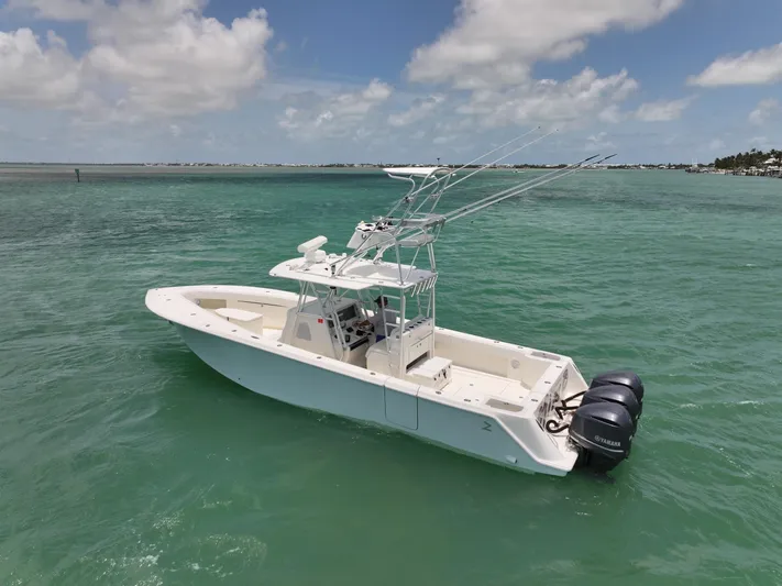  Yacht Photos Pics 2015 SeaVee 370z boat on clear turquoise water under a partly cloudy sky.