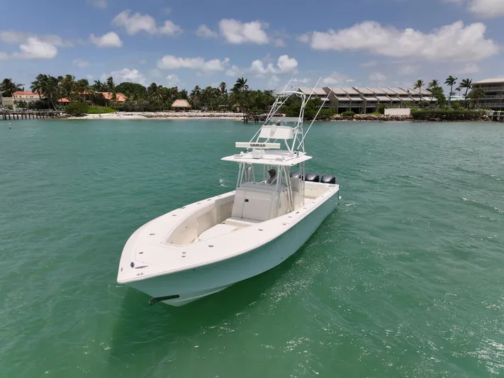  Yacht Photos Pics 2015 SeaVee 370z boat on turquoise water near a tropical shoreline.