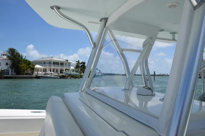  Yacht Photos Pics SeaVee 370z 2015 boat cruising near waterfront homes on a sunny day.