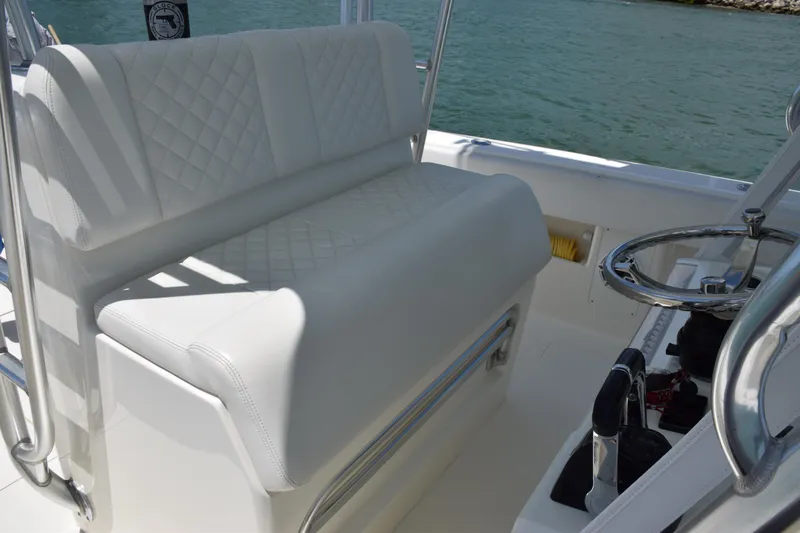  Yacht Photos Pics 2015 SeaVee 370z boat with white cushioned seating and steering wheel.