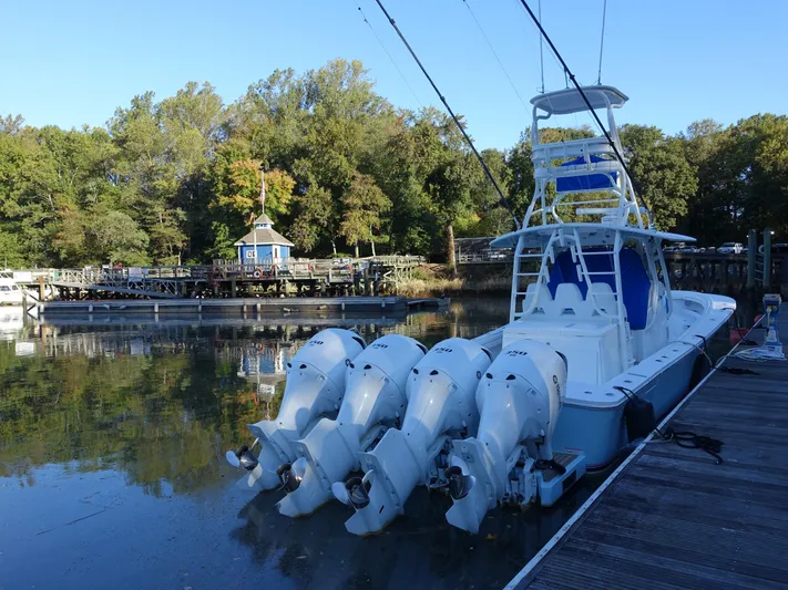 Yacht Photos Pics 2016 Regulator 41 boat docked with four engines, surrounded by trees and calm water.