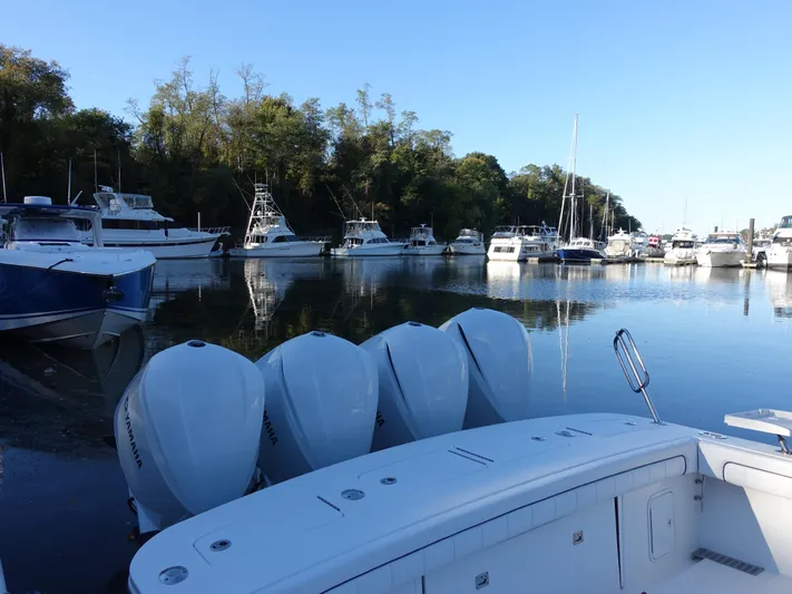  Yacht Photos Pics 2016 Regulator 41 boat with multiple engines docked in a marina.
