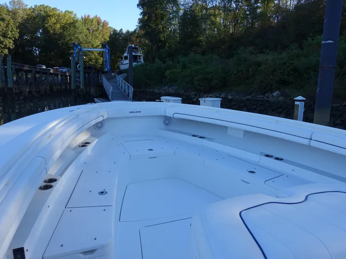  Yacht Photos Pics 2016 Regulator 41 boat docked near lush greenery and a wooden pier.