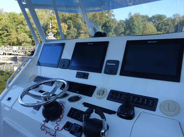  Yacht Photos Pics Regulator 41 boat helm with Raymarine displays and steering wheel, 2016 model.