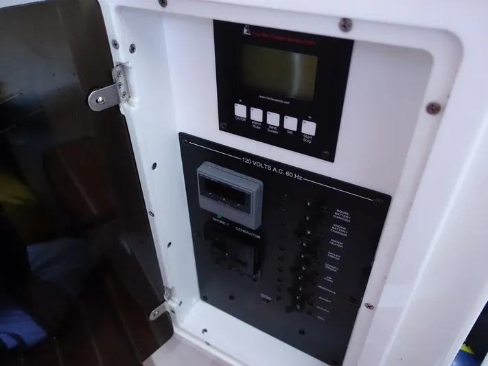  Yacht Photos Pics Electrical control panel inside a 2016 Regulator 41 boat, featuring various switches and a display.