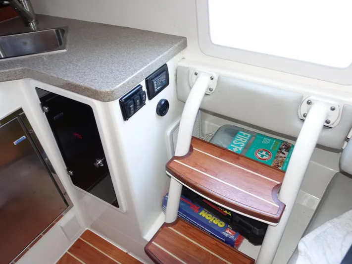  Yacht Photos Pics 2016 Regulator 41 cabin interior with wooden steps, countertop, and storage.