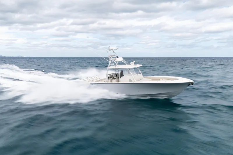  Yacht Photos Pics 2026 SeaVee 420Z boat cruising swiftly on open ocean under cloudy sky.