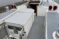 Sailing yacht deck of 1992 Devonport Challenge 67, featuring control panels and seating area.