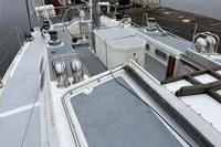 Deck view of 1992 Devonport Challenge 67 yacht, featuring winches and steering wheel.