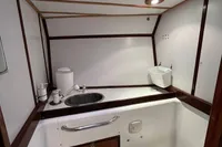Compact bathroom in 1992 Devonport Challenge 67 yacht with skylight and modern amenities.
