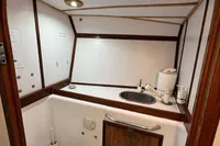 Bathroom interior of 1992 Devonport Challenge 67 yacht, featuring sink and toilet.
