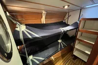 Interior of 1992 Devonport Challenge 67 yacht with bunk beds and wooden paneling.