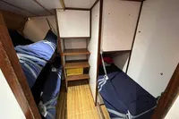 Interior cabin of 1992 Devonport Challenge 67 yacht with bunk beds and wooden flooring.