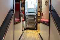 Interior view of 1992 Devonport Challenge 67 yacht, featuring wooden flooring and red seating.
