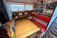 Navigation station inside 1992 Devonport Challenge 67 yacht with control panels and seating.