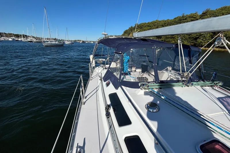 Sandman Yacht Photos Pics 2004 Catalina 400 MkII sailboat on calm water, surrounded by other boats and lush greenery.